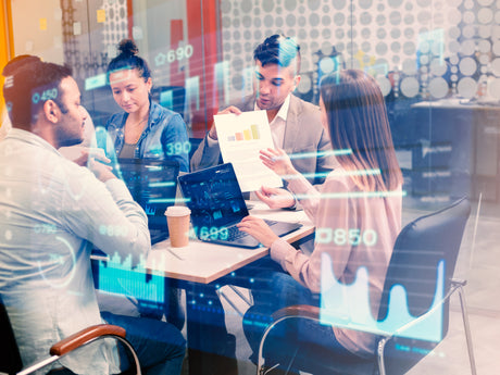 Professionals collaborating on strategies for "Mastering Leadership in the AI Era: Strategies" using data insights.