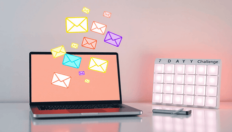 Laptop with colorful email icons and a glowing 7-day challenge calendar grid on a clean, modern workspace background.